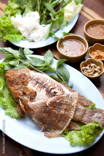 Grilled Tilapia with Salt and Crispy Flavor Grilled over an open flame to achieve a rich and smoky flavor with a dipping sauce and fresh herbs