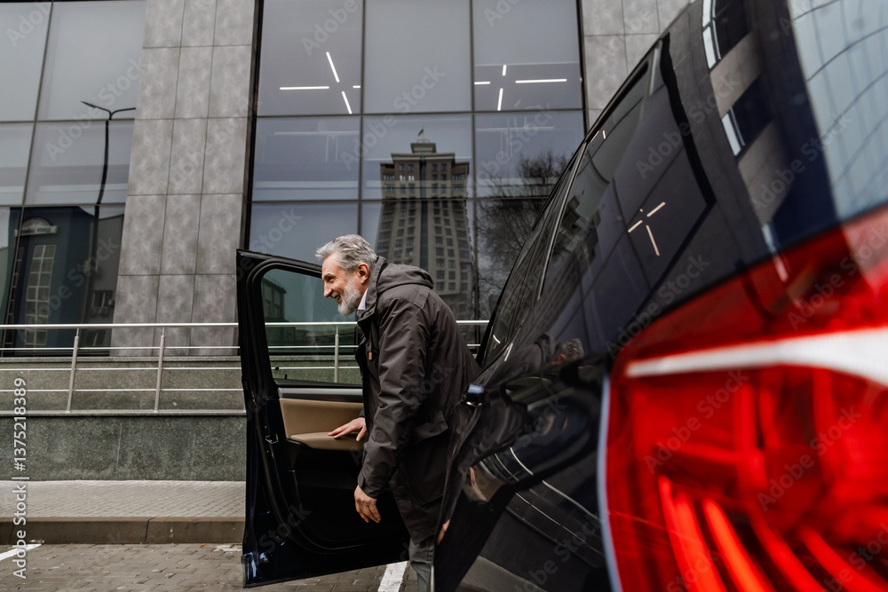 A middle-aged White businessman in his late 50s, dressed in a black coat, stepping out of his parked car with a happy expression on his face, as he's parked near a large corporate building on a street A middle-aged White businessman in his late 50s, dressed in a black coat, stepping out of his parked car with a happy expression on his face, as he's parked near a large corporate building on a street