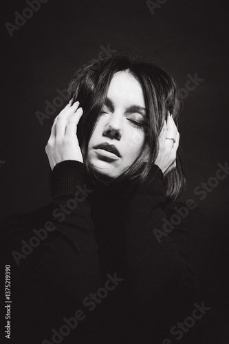 Portrait of a woman with dark hair, done in low key style.