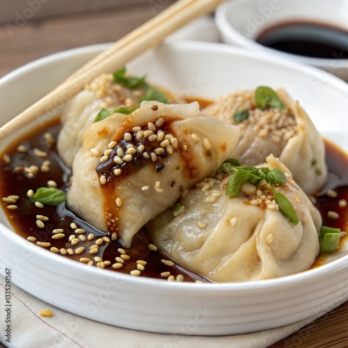 Steamed Dumplings Topped With Sesame Seed & Basil in Dark Sauce, Bowl, Chopsticks