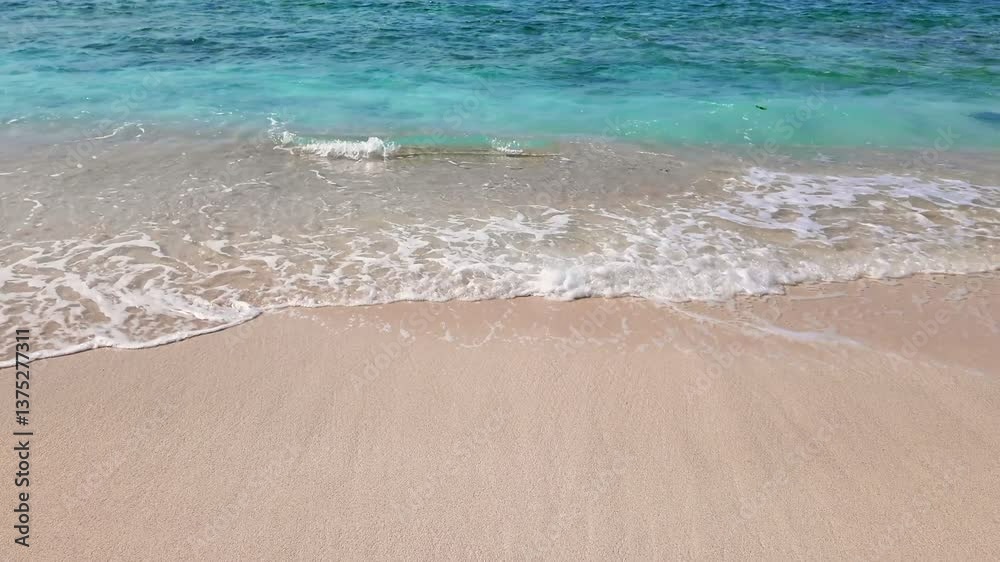 static shot of ocean with calm waves reaching shore of sand beach on tropical Gili island Indonesia during sunny day, holidays, vacations, relax, paradise and tourism concept, slow motion static shot of ocean with calm waves reaching shore of sand beach on tropical Gili island Indonesia during sunny day, holidays, vacations, relax, paradise and tourism concept, slow motion