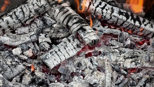 Bonfire in the yard. Preparation for a picnic, barbecue at the campfire, rest at the end of the week. Firewood is burning in the barbecue, it is very hot. Flame from dry firewood, fuel for cooking