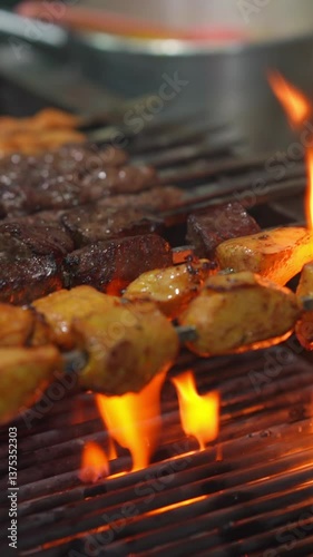 Grilling delicious kebabs over open flames food preparation area culinary art vibrant kitchen environment close-up perspective flavorful cooking concept
