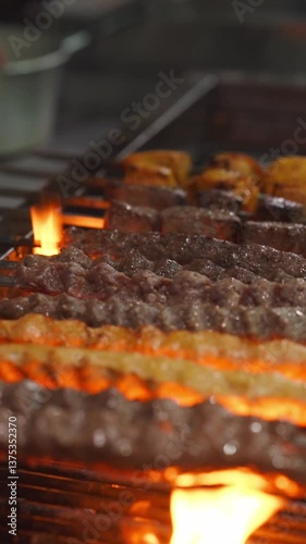 Grilling delicious kebabs over open flames food preparation area culinary art vibrant kitchen environment close-up perspective flavorful cooking concept