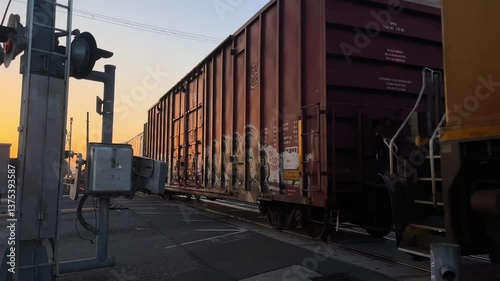 Train passing through Oakland, California during golden hour with safety concerns