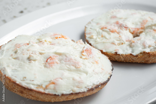 A closeup view of a cream cheese and lox bagel.