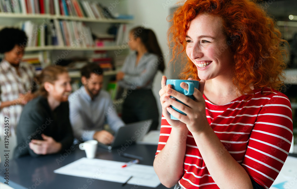 © NDABCREATIVITY - Portrait of young happy success woman working in a busy modern workplace, Startup coworker concept