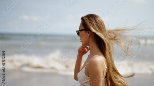Portrait of asian woman walking along the sea at the beach. Living near oceanside.