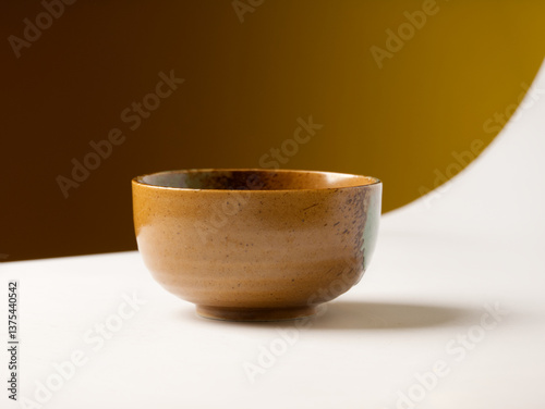 An empty bowl is placed on the white floor table in the kitchen.