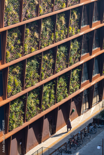 Architectural detail of vertical greenery on facade in Nordhavn, Copenhagen. Sustainable building with geometry and contemporary urban identity.