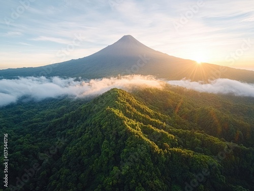 Majestic volcano rises above lush green forest under glowing sunrise in El Salvador