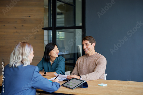 Mixed race couple meeting financial advisor in office