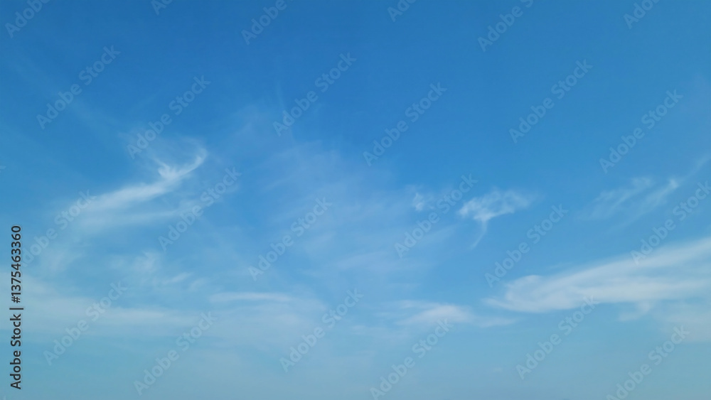 Obraz premium Cloudscape, Beautiful blue sky with wispy, cirrus clouds stretching across the horizon, for a background