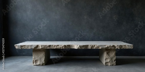 Rough-hewn stone coffee table with a rustic, minimalist design, sitting on a sleek, neutral floor against a dark textured wall.