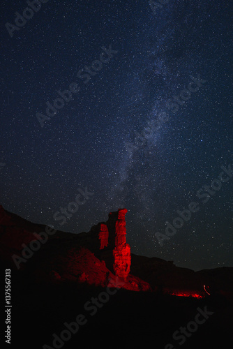 starry sky over a canyon illuminated by a red lantern