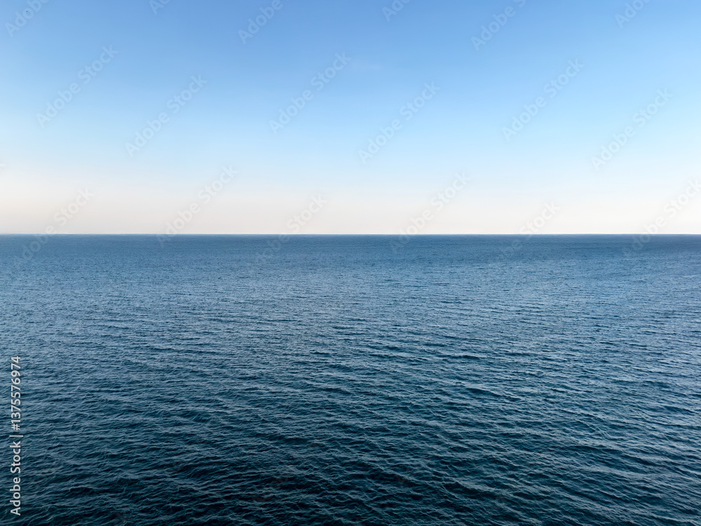 Obraz premium minimalist seascape with calm sea and clear sky background with copy space. perfect horizon. waterline. calm sea surface