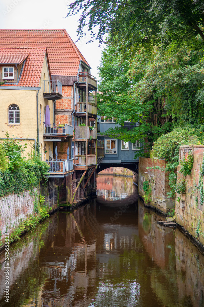Charming Historic Canal with Buildings and Lush Greenery