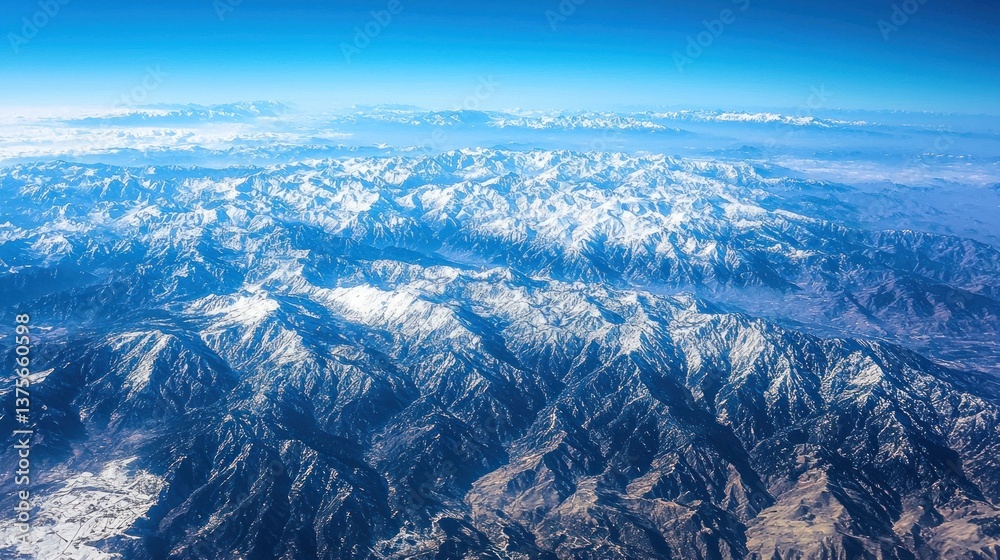 Fototapeta premium Aerial view of snow-capped mountain range.