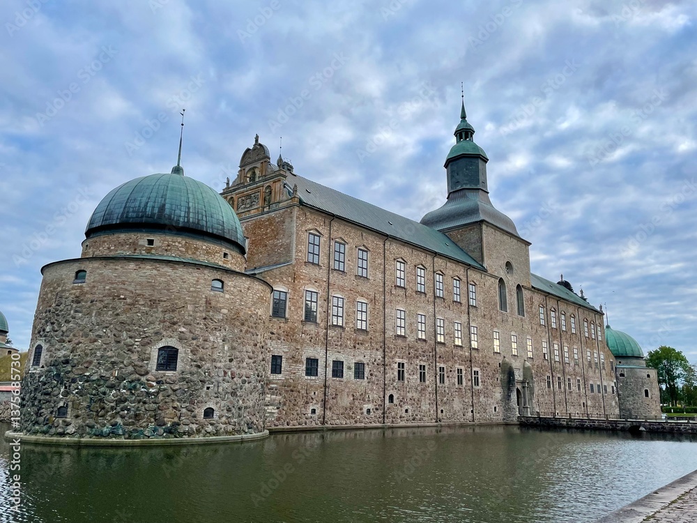 Fototapeta premium Vadstena castle in Vadstena, Sweden. Vadstena Castle is a Renaissance fortress located in Vadstena, Sweden. It features large, rounded stone turrets and a distinctive central tower with a spire. 