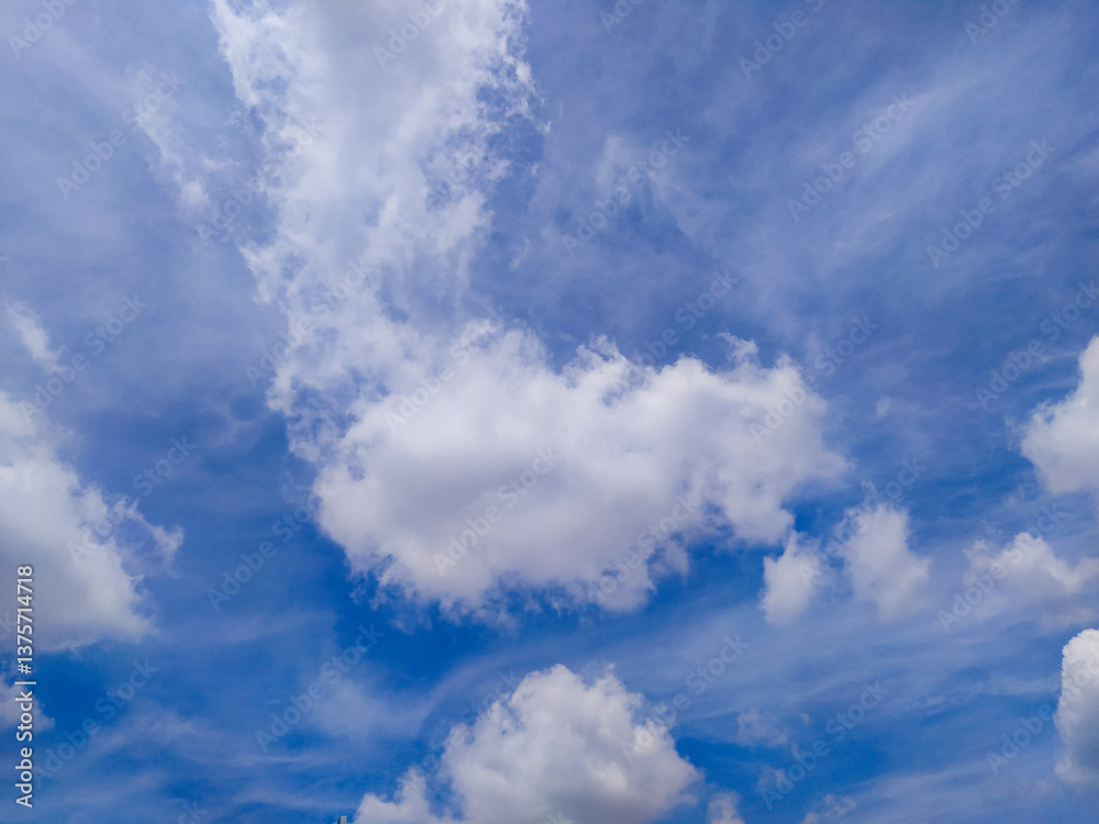 Fototapeta premium Bright Blue Sky with Moving White Clouds