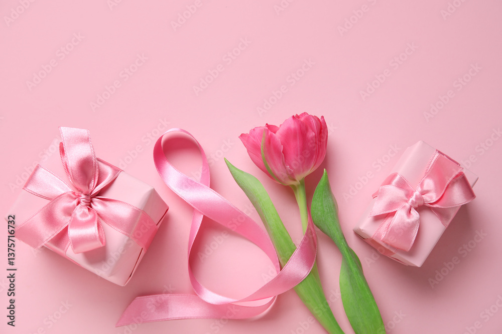 Composition with figure 8 made of ribbon, tulip flower and gift boxes on pink background. International Women's Day celebration Composition with figure 8 made of ribbon, tulip flower and gift boxes on pink background. International Women's Day celebration