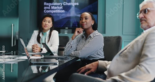 Presentation, group and business woman listening for market competition, financial regulation and training. Teamwork, cooperation and manager in office for conference meeting, workshop and coaching