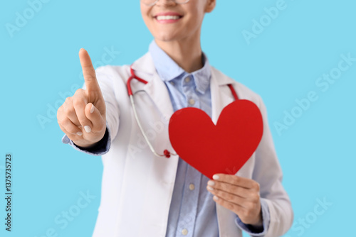 Female doctor holding red h...