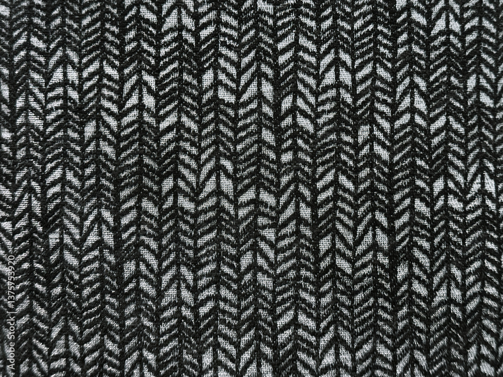 Close up of upholstery fabric in chevron pattern, in black color. Inverted v shape chevron pattern seamless background texture. Close up of upholstery fabric in chevron pattern, in black color. Inverted v shape chevron pattern seamless background texture.