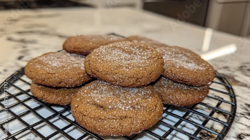 A batch of soft and chewy molasses cookies with a cracked sugar-coated top.