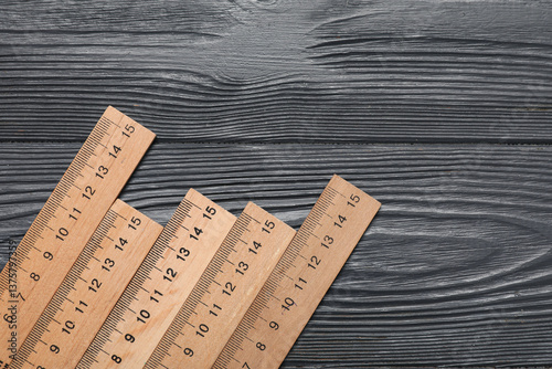 Rulers on dark wooden background