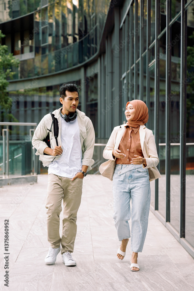 Fototapeta premium University students walking and talking on campus