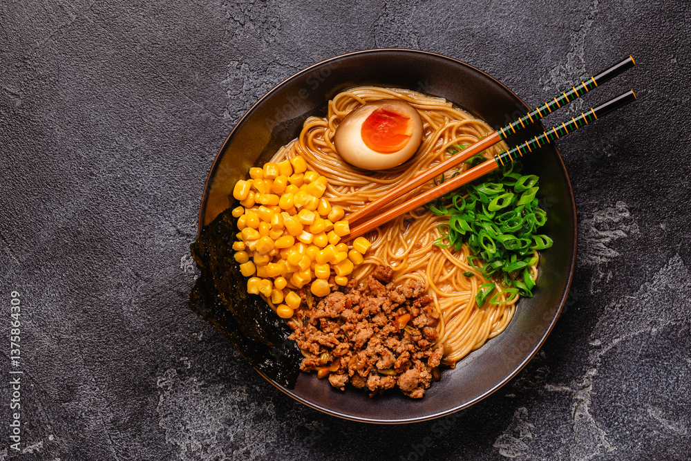 A bowl of ramen with noodles, meat and green onions.