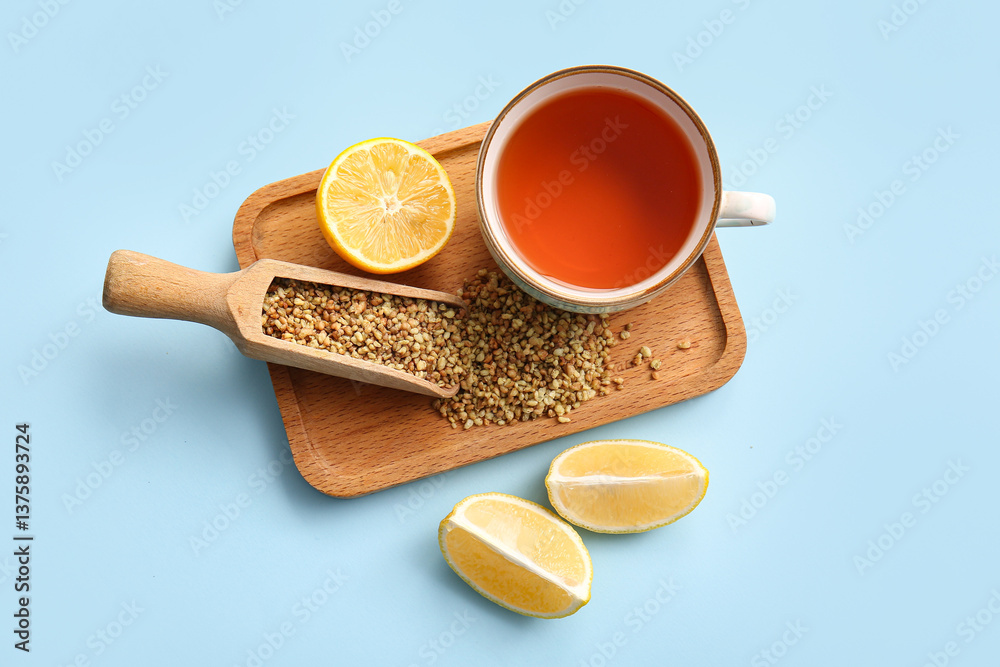 Cup of hot buckwheat tea with lemon on blue background Cup of hot buckwheat tea with lemon on blue background