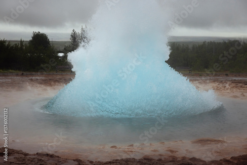 Strokkur geyser splashing hot water photo