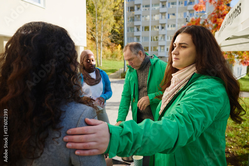 Female volunteer with hand on shoulder of woman at park