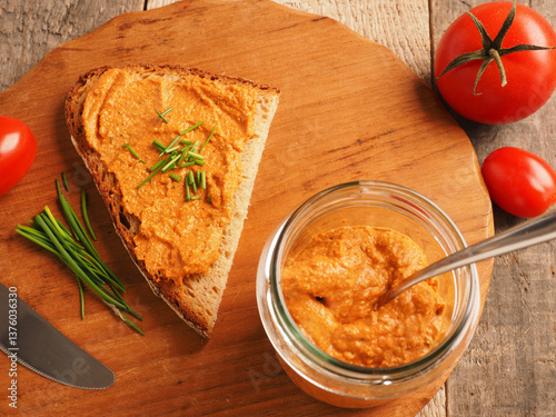 Vegan tomato spread on rustic spelt bread garnished with chives