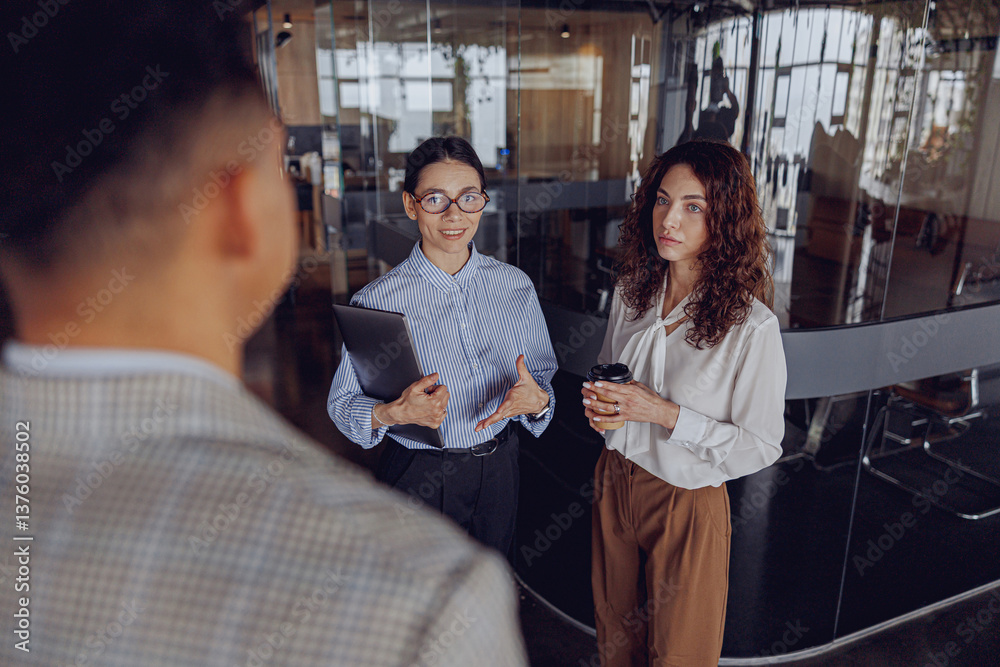 A dedicated team actively engages in a meaningful professional discussion within a contemporary office environment A dedicated team actively engages in a meaningful professional discussion within a contemporary office environment