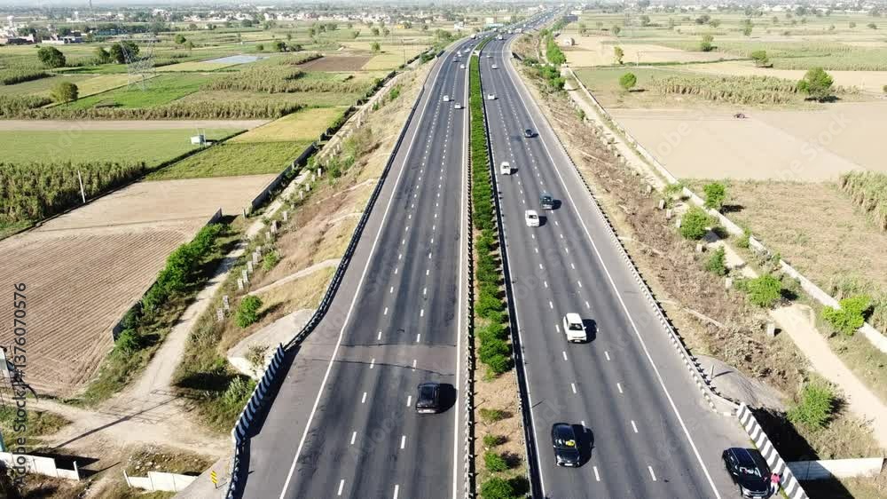 Spectacular aerial view on a highway road with still camera, showing vehicles moving fast on the asphalt freeway Spectacular aerial view on a highway road with still camera, showing vehicles moving fast on the asphalt freeway