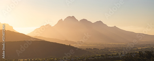 Simon's Mountain, South Africa, mountains silhouettes in sunset light, banner. Golden hour, natural landscape with tonal perspective