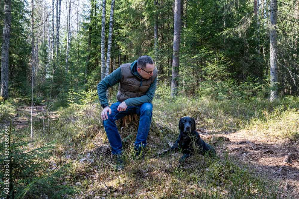 Man and Dog Resting Together in Forest – Peaceful Moment of Bonding and Companionship in Nature Man and Dog Resting Together in Forest – Peaceful Moment of Bonding and Companionship in Nature