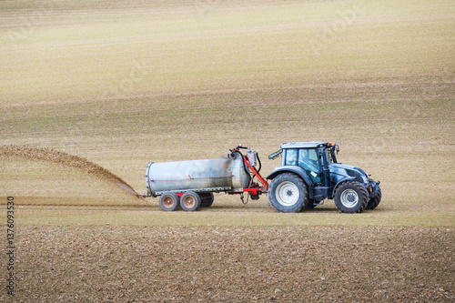 Farmer spreading liquid manure