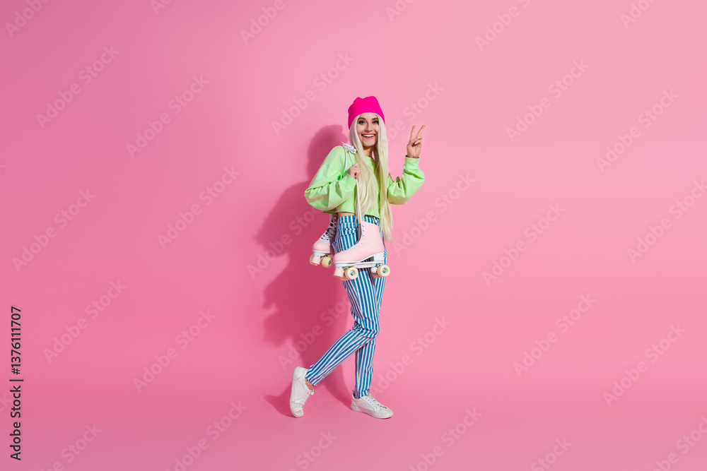 Young stylish blonde woman posing casually with roller skates against pink background showcasing trendy fashion and cheerful vibes Young stylish blonde woman posing casually with roller skates against pink background showcasing trendy fashion and cheerful vibes
