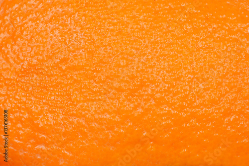 A close-up shot of an orange peel showcasing its textured surface and vibrant color