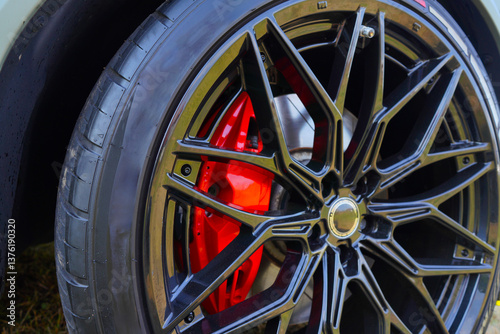 Wallpaper Mural Alloy wheel with calipers and racing brakes of the sport car. Racing brake disc and low profile tyres. Race car test driving. Lower-profile tires of drag and drift cars. High-performance sports cars. Torontodigital.ca