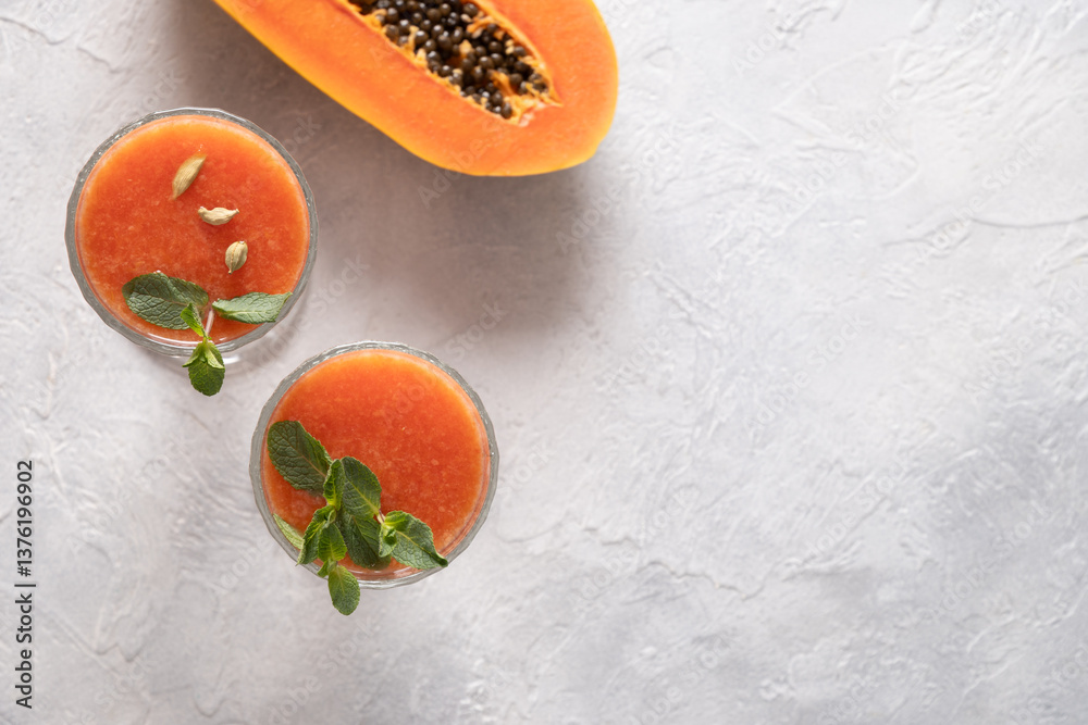 Asian popular freshness Papaya lassi , smoothie made of water, spices and ice. Traditional ayurvedic beverage in India and Sri Lanka. Close up. View from above.