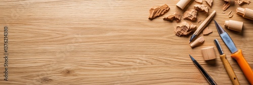 Wood Carving Tools and Wood Shavings on Wooden Table - Close-up overhead shot of wood carving tools, wood shavings, and wood scraps arranged on a light brown wooden surface