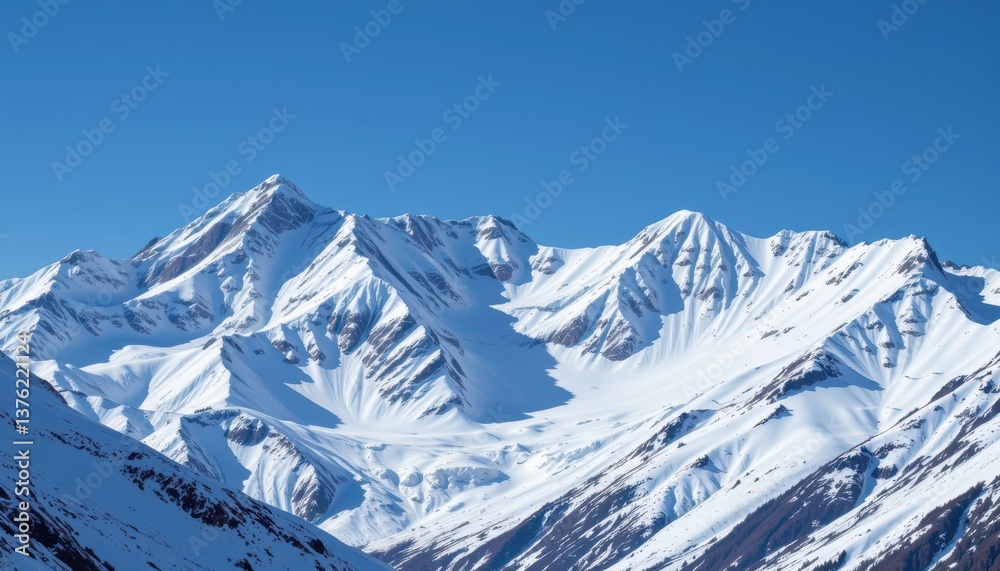 Obraz premium Icy Mountain Peaks A majestic mountain range with glistening icy peaks and a clear blue sky, evoking a sense of serenity.