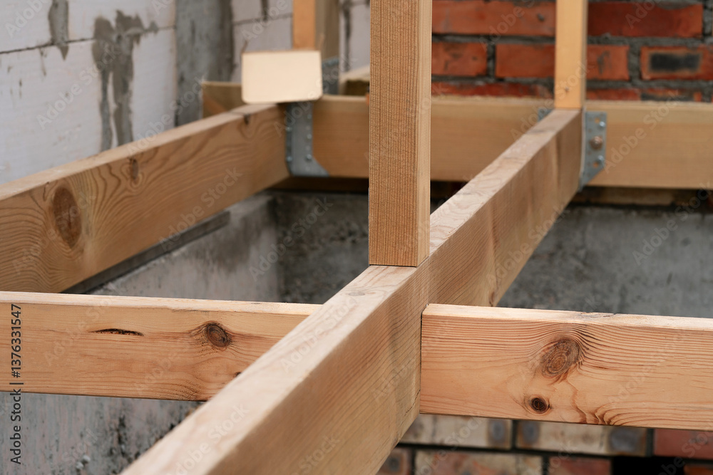 Making a wooden roof. Close-up wooden roof trusses in a frame structure. Steel beam connections. Wooden roof structure Making a wooden roof. Close-up wooden roof trusses in a frame structure. Steel beam connections. Wooden roof structure