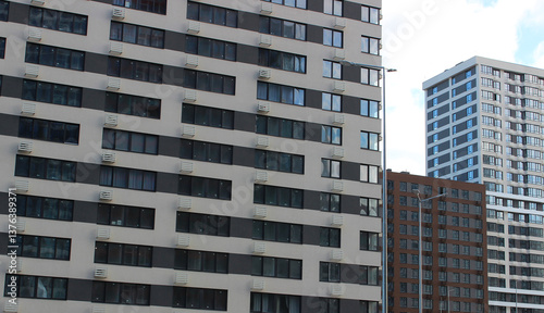 Newly built residential area with modern square and rectangular houses. Residential buildings with different number of floors in a modern city