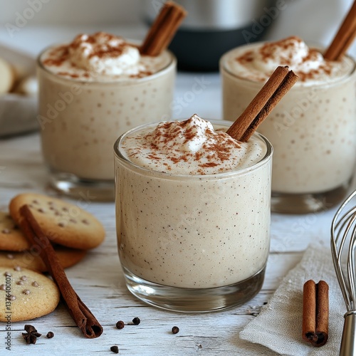 Eggnog mousse dessert garnished with whipped cream and cinnamon sticks